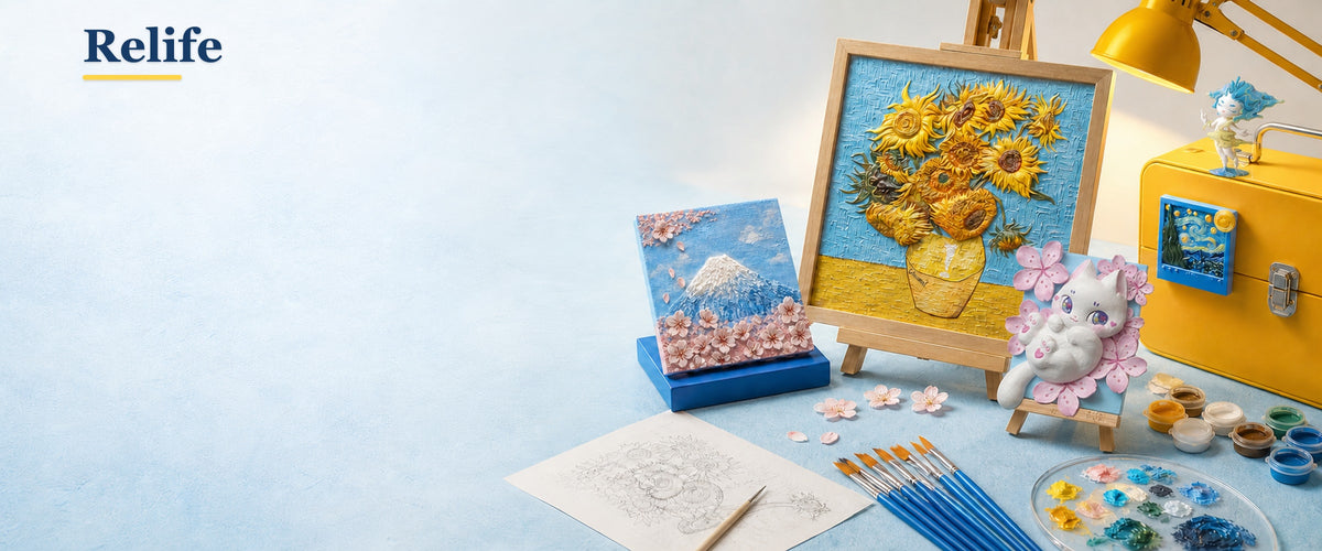 ReLife relief artworks on easels and a fridge, with an unpainted piece, brushes and paints